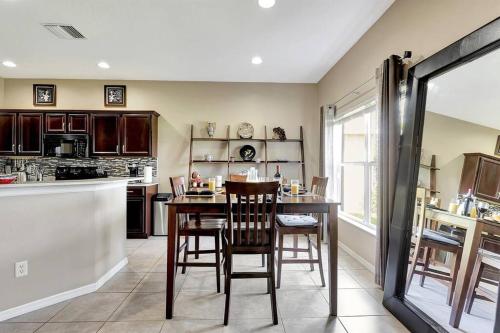 a kitchen with a table and chairs and a counter at Golf Course Community! Amazing Home for 8 Guests in Valrico