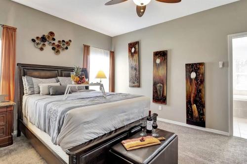 a bedroom with a large bed and a ceiling fan at Golf Course Community! Amazing Home for 8 Guests in Valrico