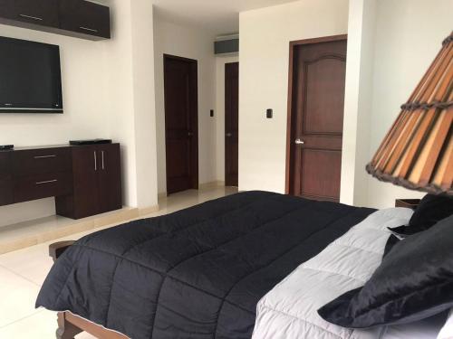 Ένα ή περισσότερα κρεβάτια σε δωμάτιο στο Casa Vacacional Jpol