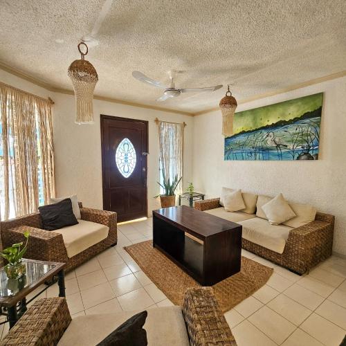 a living room with a couch and a table at Casa Alux Azul in Valladolid