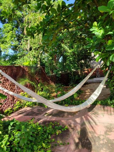 a hammock hanging from a tree in a garden at Casa Alux Azul in Valladolid