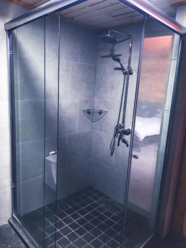 a shower with a glass door in a bathroom at Cabañas Santa Barbara in Mazamitla