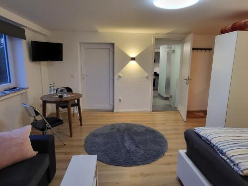 a living room with a bed and a table at Andreas Zugspitzblick in Murnau am Staffelsee