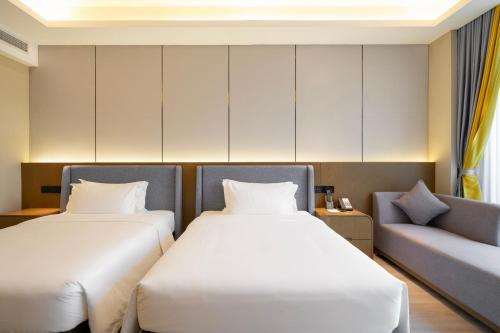 a room with two beds and a couch at DongHu Resort Hotel in Sihanoukville
