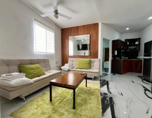 a living room with a couch and a table at La Puerta Blanca Penthouse #8 in Puerto Vallarta