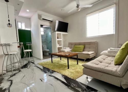 a living room with a couch and a coffee table at La Puerta Blanca Penthouse #8 in Puerto Vallarta