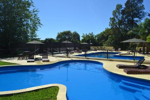 a large swimming pool with chairs and umbrellas at Casablanca in Victoria