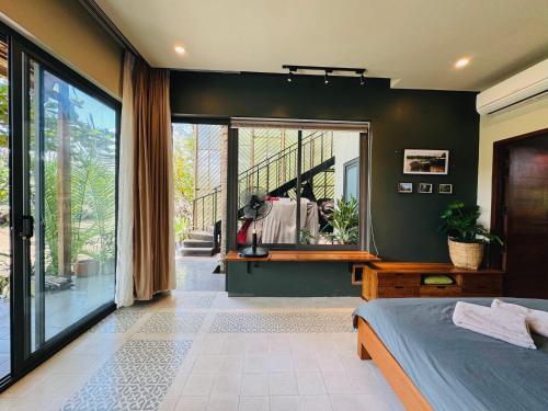 a bedroom with a bed and a large mirror at Comfy Riverside Mekong homestay Ben Tre in Ấp Phú Hòa (3)
