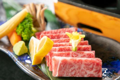 a plate of food with fruit and vegetables on it at Tennomaru in Gamagori
