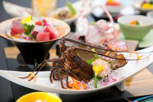 a plate of food with a lobster on it at Tennomaru in Gamagori