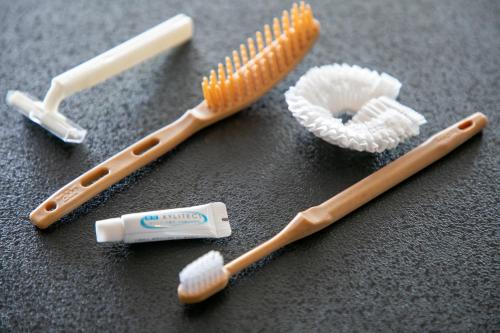 a group of toothbrushes and toothpaste on a table at Tennomaru in Gamagori