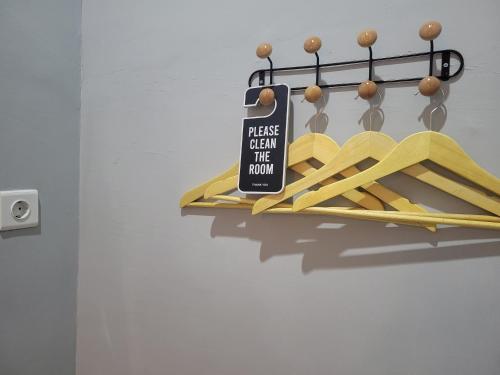a sign hanging on a rack with baseballoons at 9 Residences Seminyak in Seminyak