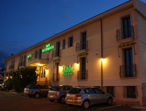 cars parked in front of a building at Hotel Stella 2000 in Olbia