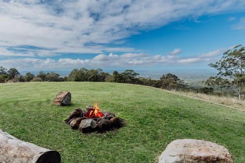 a fire in the middle of a grass field at Acreage property, pet friendly, outdoor campfire in Bald Knob