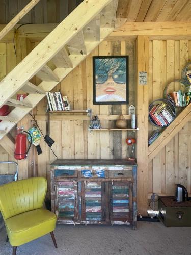 a room with a wooden attic with a desk and a chair at Camping Baleia in Pui