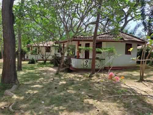 a small house in the middle of some trees at Calm Garden Cabanas in Tangalle