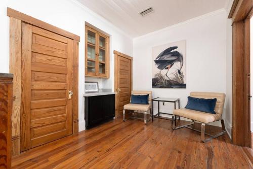 a room with two chairs and a table and a door at Be A Nomad - Combined Pool Home 1 blck to Beach in Jacksonville Beach