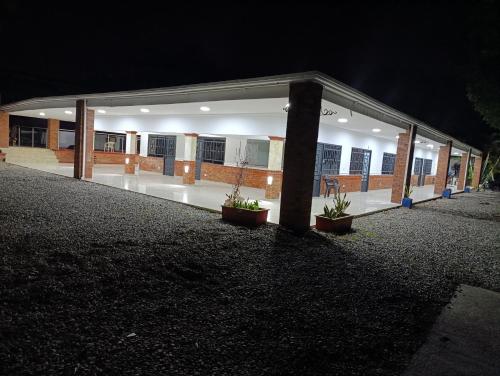 a building at night with potted plants in front of it at Quinta de San Pedro in Villavicencio