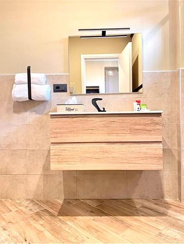 a bathroom with a sink and a mirror at Golden House-Super View On Turin in Turin