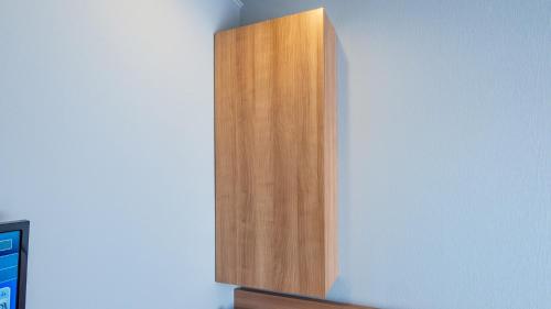 a wooden cabinet on the corner of a wall at Toyoko Inn Koriyama in Koriyama