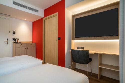 Ένα ή περισσότερα κρεβάτια σε δωμάτιο στο Hampton By Hilton Locarno