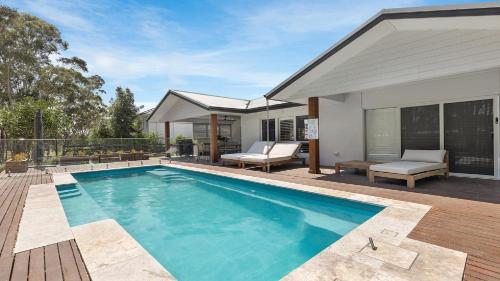 a swimming pool in the backyard of a house at Hunter Dreaming in Pokolbin