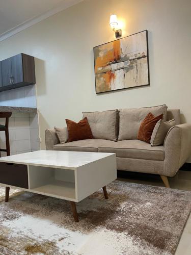 a living room with a couch and a coffee table at Cozy Home in Entebbe in Entebbe