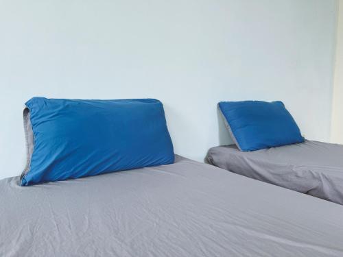 two blue pillows sitting on top of a bed at 東海獨角獸 in Longjing