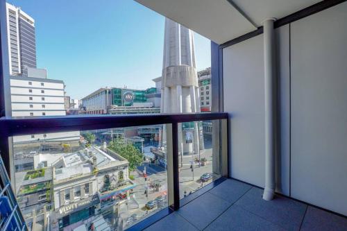 a view of a city from a window in a building at 2-Bs Suite Adjacent to Sky Tower in Auckland