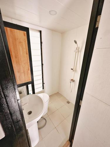 a bathroom with a toilet and a sink at SimoyNorte Private Resort Beneg, Botolan, Zambales, Philippines in Zambales