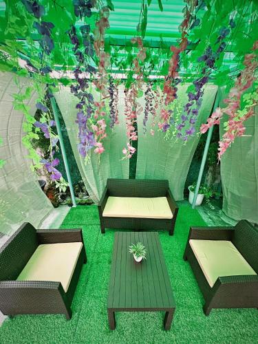a patio with two tables and flowers in a tent at SimoyNorte Private Resort Beneg, Botolan, Zambales, Philippines in Zambales