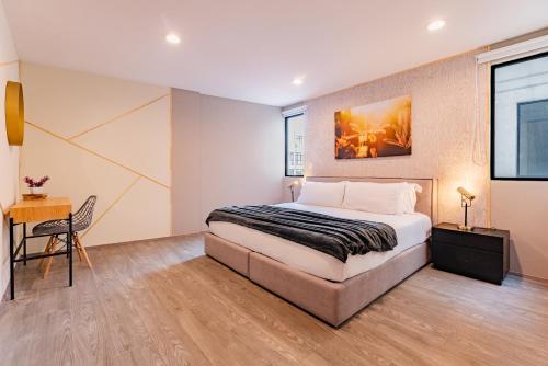 a bedroom with a king sized bed and a desk at Roma Sur Apartments by VH in Mexico City
