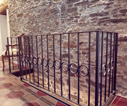 a wrought iron fence in front of a stone wall at Casa Longhi in Orta San Giulio