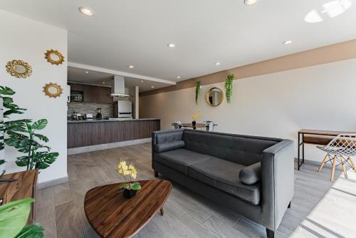 a living room with a couch and a table at Roma Sur Apartments by VH in Mexico City