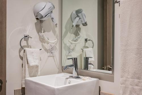 a bathroom with a sink and a mirror at Roma Sur Apartments by VH in Mexico City