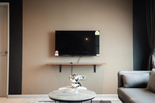 a living room with a tv and a coffee table at Jesselton Quay by Pinstay in Kota Kinabalu