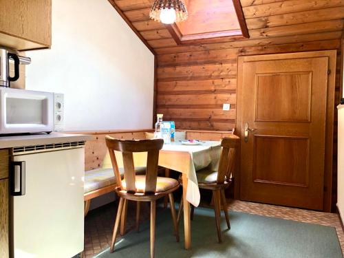 a kitchen with a table and chairs and a microwave at Stöcklhof in Dienten am Hochkönig