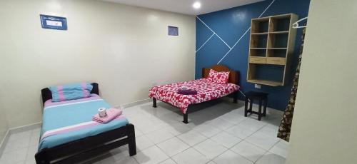 Ένα ή περισσότερα κρεβάτια σε δωμάτιο στο JC ITEN Guest House