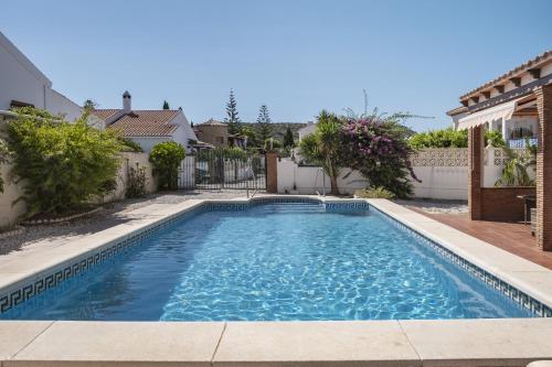 a swimming pool in the backyard of a house at Villa ju-mi in El Cerro
