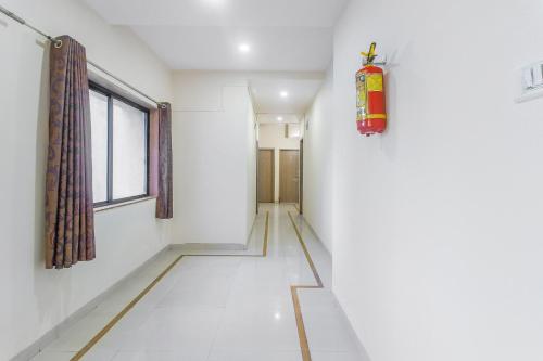 a corridor with a fire extinguisher in a room at Hotel O Gokul Residency in Kharadi