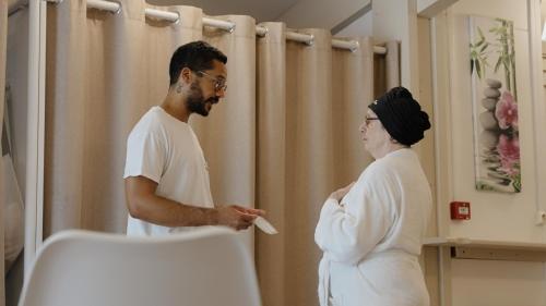 a man and a woman standing in front of a mirror at Logis Thermal in Saubusse