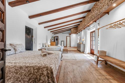 a bedroom with a bed with a cat laying on it at Finca Especial El Pino en Esporles in Esporles