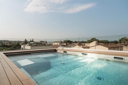 a swimming pool on the roof of a building at WANDERLUST HOTEL - SUITE & SPA - APARTMENTS & VILLAS - Bardolino, Lago di Garda - Verona in Bardolino