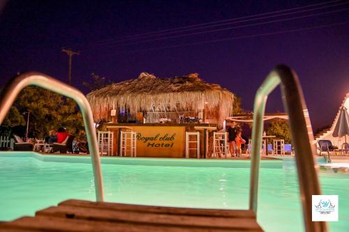 a resort swimming pool with a bar in the background at Royal Club Hotel - Aqua Poolside Bliss in Kamenitsotaíika