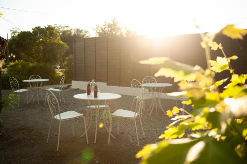 a group of tables and chairs in a garden at Logis Thermal in Saubusse