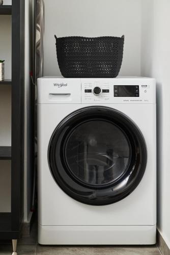 a white washing machine with a basket on top at Votsalo in Ierápetra