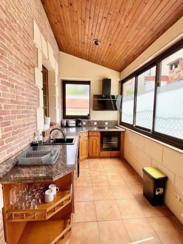 a kitchen with a sink and some windows at 3 bedrooms house - garden - Parking, Antony Center near Paris and Orly in Antony