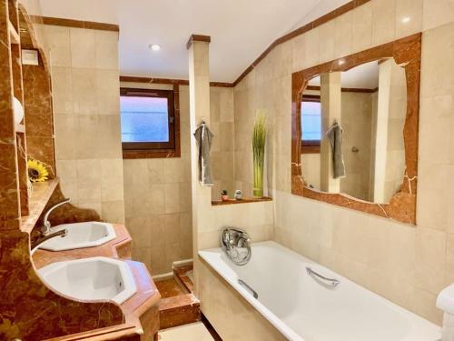 a bathroom with a tub and a sink and a bath tub at 3 bedrooms house - garden - Parking, Antony Center near Paris and Orly in Antony