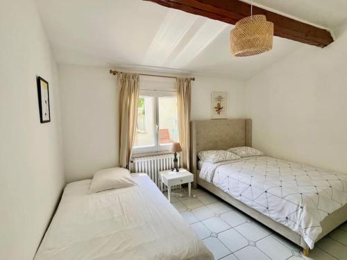 a bedroom with two beds and a window at 3 bedrooms house - garden - Parking, Antony Center near Paris and Orly in Antony