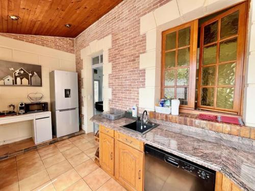 a kitchen with a sink and a refrigerator at 3 bedrooms house - garden - Parking, Antony Center near Paris and Orly in Antony